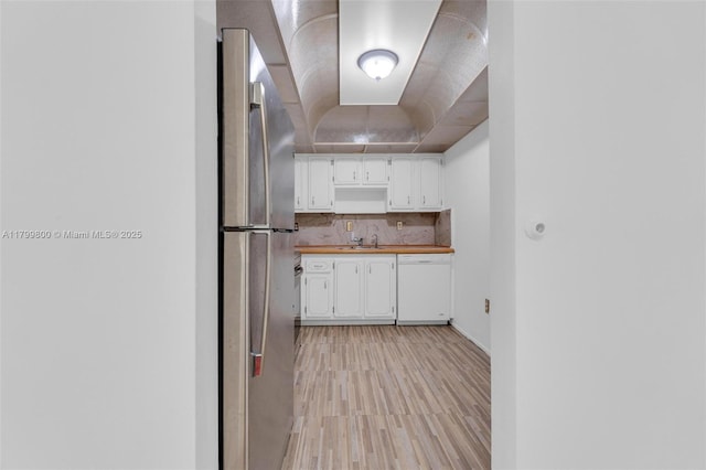 7300 NW 17th St Unit 203, Plantation, FL 33313 - kitchen with dishwasher, freestanding refrigerator, white cabinets, light wood-type flooring, and wooden counters