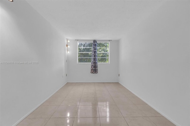 7300 NW 17th St Unit 203, Plantation, FL 33313 - empty room with light tile patterned flooring and baseboards