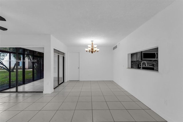 20260 NE 3rd Ct Unit 5, Miami, FL 33179 - spare room featuring a chandelier and ceiling fan