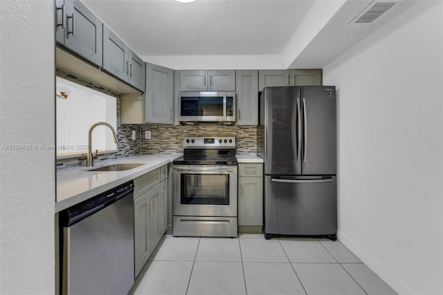 20260 NE 3rd Ct Unit 5, Miami, FL 33179 - kitchen featuring appliances with stainless steel finishes, a sink, tasteful backsplash, and light tile patterned flooring