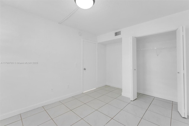 20260 NE 3rd Ct Unit 5, Miami, FL 33179 - unfurnished bedroom with a closet and light tile patterned floors