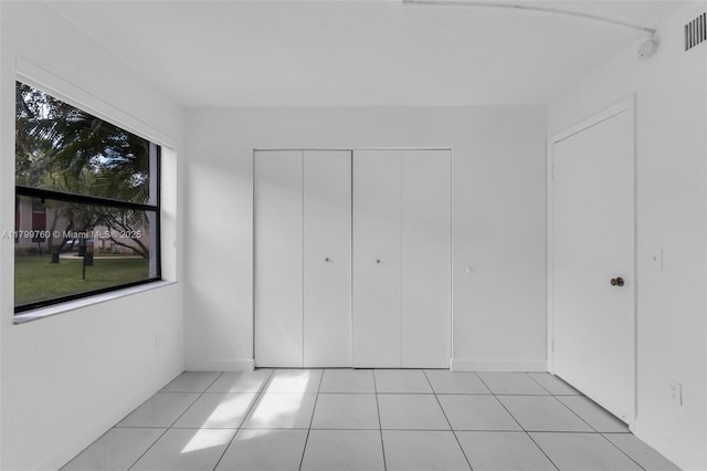 20260 NE 3rd Ct Unit 5, Miami, FL 33179 - unfurnished bedroom with light tile patterned floors and a closet