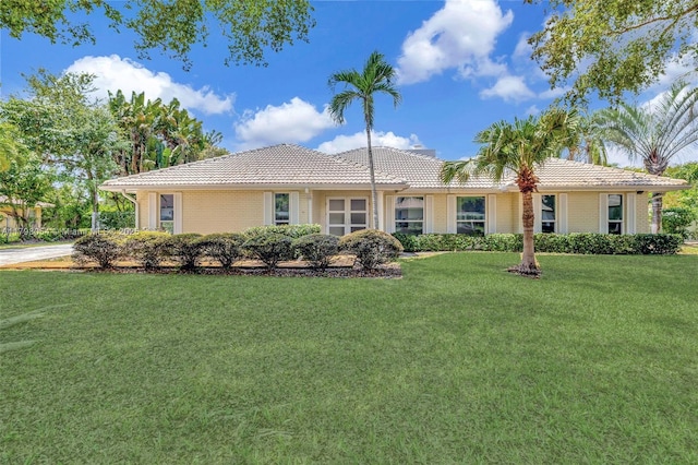 2730 NW 105th Ter, Coral Springs, FL 33065 - ranch-style house with a tiled roof and a front yard