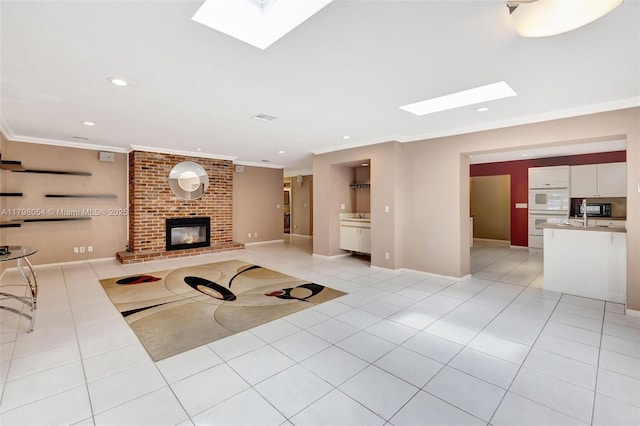 2730 NW 105th Ter, Coral Springs, FL 33065 - unfurnished living room featuring a skylight, light tile patterned flooring, ornamental molding, a brick fireplace, and recessed lighting