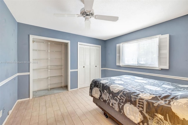 2730 NW 105th Ter, Coral Springs, FL 33065 - bedroom featuring wood finished floors, baseboards, a ceiling fan, and two closets