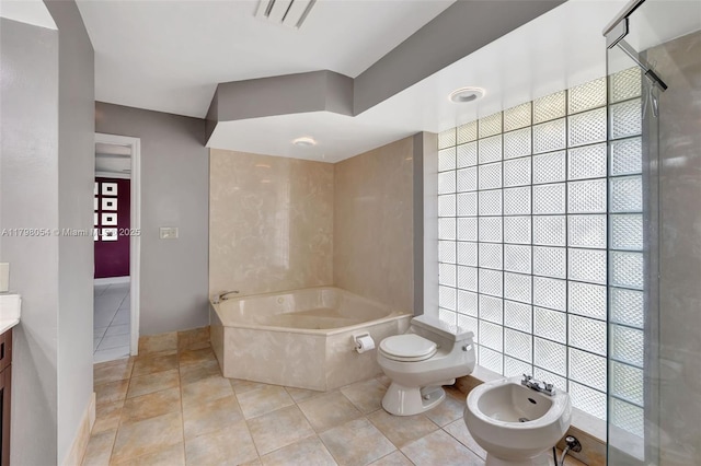 2730 NW 105th Ter, Coral Springs, FL 33065 - bathroom featuring a bidet, tile patterned floors, a garden tub, vanity, and toilet