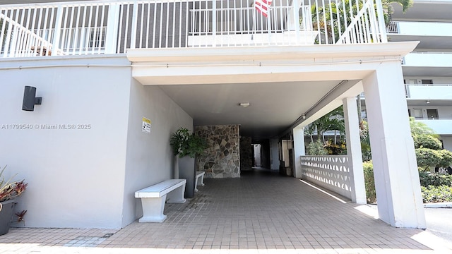 view of patio / terrace featuring a carport and a balcony