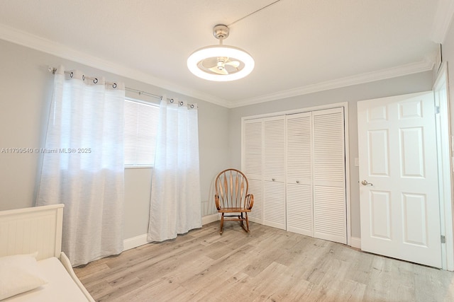 unfurnished bedroom featuring ornamental molding, light wood-style floors, a closet, and baseboards