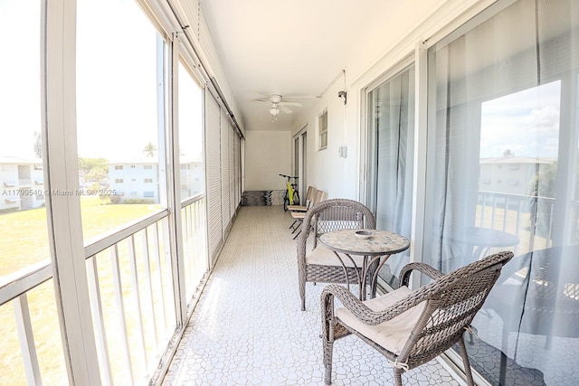 sunroom / solarium featuring ceiling fan