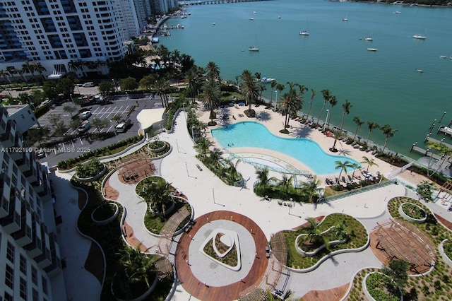 view of property location with a pool area and a nearby body of water