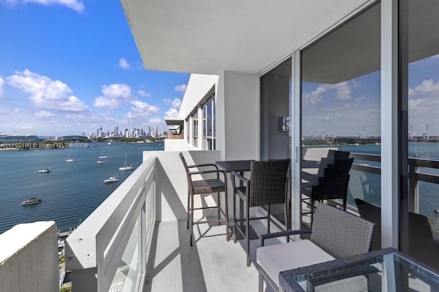 balcony featuring a view of city and a water view