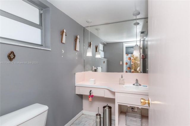 18555 NE 14th Ave Unit 612, Miami, FL 33179 - half bathroom featuring toilet, vanity, baseboards, and tile patterned floors