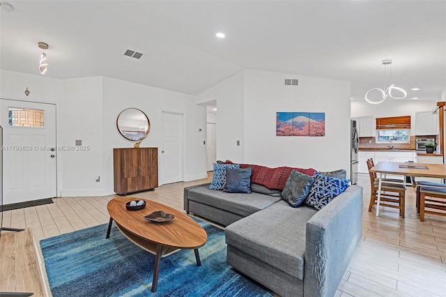 9821 W Fern Ln, Miramar, FL 33025 - living room featuring vaulted ceiling, light wood-style floors, a chandelier, and recessed lighting