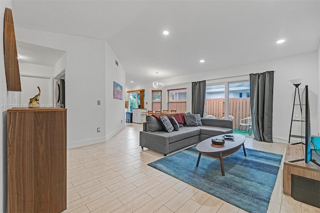 9821 W Fern Ln, Miramar, FL 33025 - living area featuring baseboards, light wood-style floors, vaulted ceiling, and recessed lighting