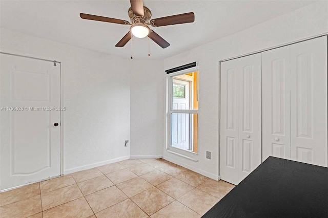 9821 W Fern Ln, Miramar, FL 33025 - unfurnished bedroom featuring light tile patterned flooring, a closet, baseboards, and a ceiling fan
