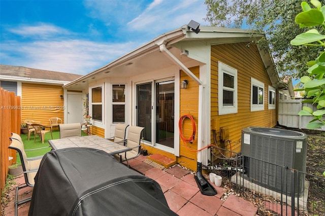 9821 W Fern Ln, Miramar, FL 33025 - rear view of house with cooling unit, fence, outdoor dining space, and a patio