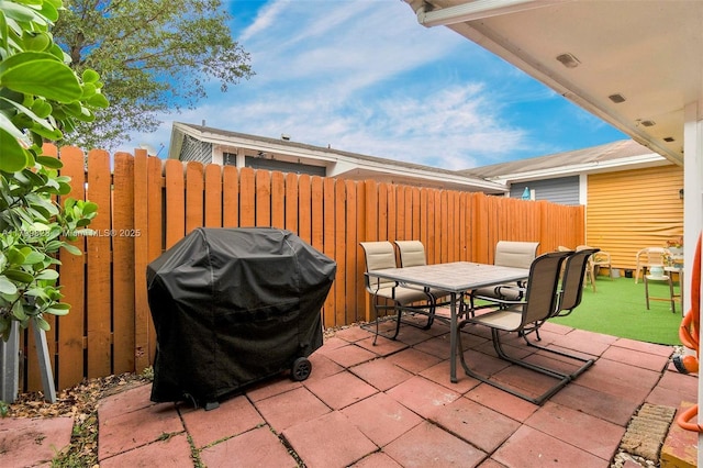9821 W Fern Ln, Miramar, FL 33025 - view of patio with grilling area, outdoor dining space, and fence