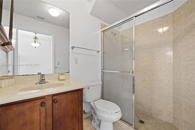 full bathroom with tiled shower, vanity, and toilet
