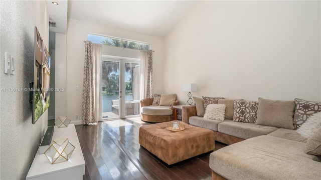 living area featuring dark wood-style floors, baseboards, and vaulted ceiling