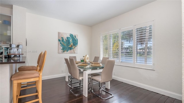 dining room with dark wood-style floors and baseboards