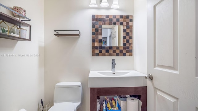 half bath featuring toilet and vanity