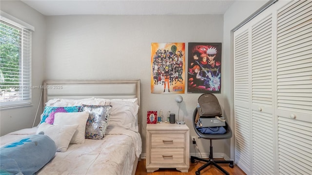 bedroom with a closet and wood finished floors
