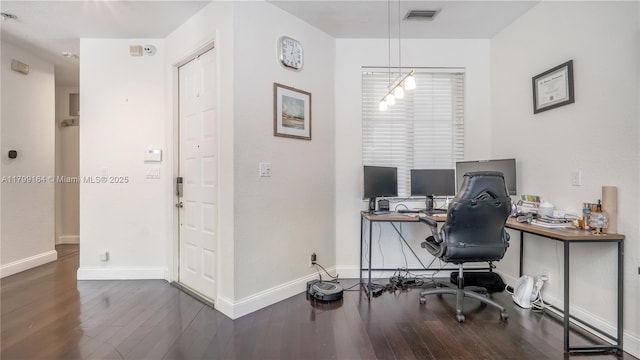 office space with wood finished floors and baseboards