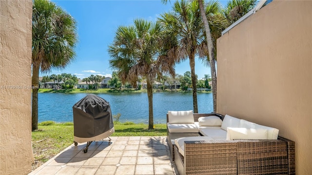 view of patio / terrace with a water view, outdoor lounge area, and area for grilling