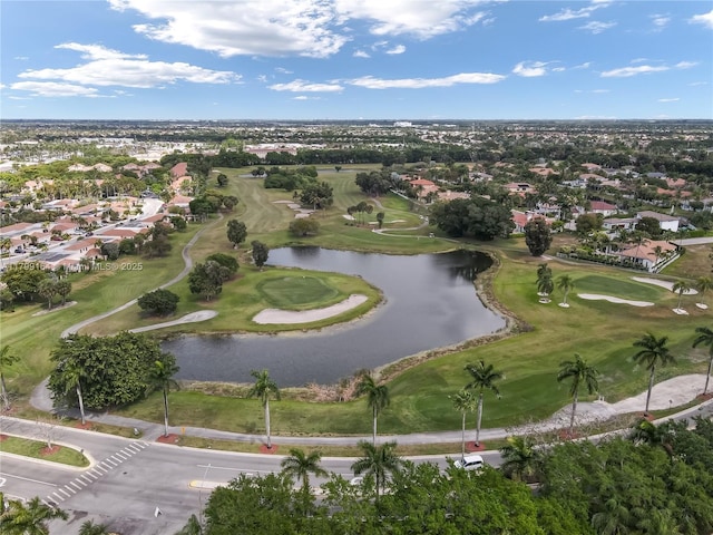 view of property location featuring a large body of water, a golf club, and nearby suburban area