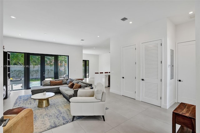 living room with electric panel, light tile patterned floors, french doors, and recessed lighting