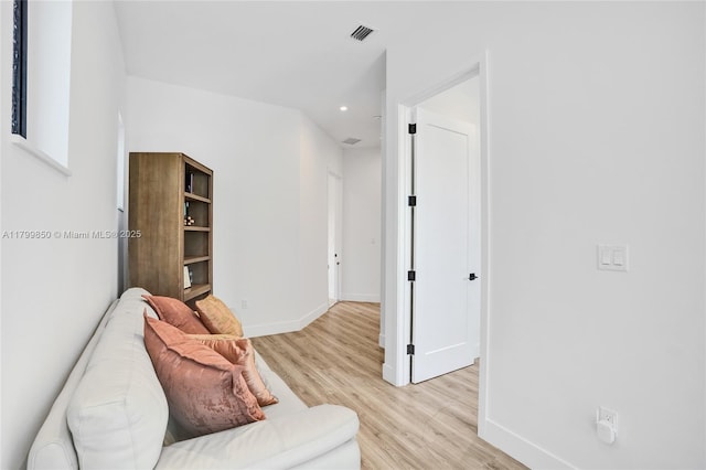 sitting room featuring baseboards, light wood-style floors, and recessed lighting