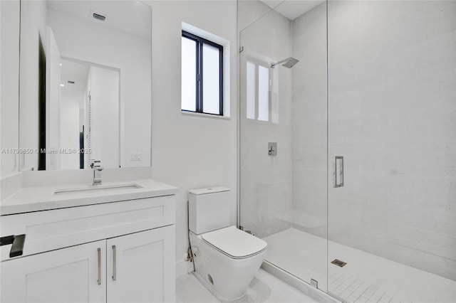 bathroom featuring a stall shower, toilet, and vanity