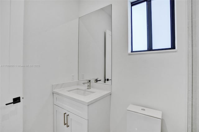 bathroom featuring toilet and vanity