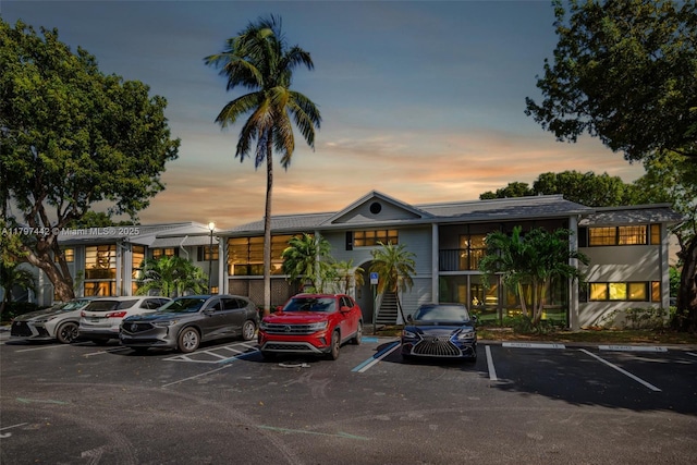 933 NE 199th St Unit 207, Miami, FL 33179 - parking at dusk featuring uncovered parking