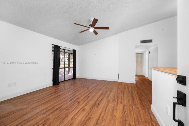 933 NE 199th St Unit 207, Miami, FL 33179 - unfurnished room with a ceiling fan, wood finished floors, a textured ceiling, baseboards, and vaulted ceiling