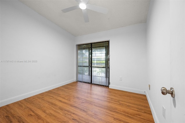 933 NE 199th St Unit 207, Miami, FL 33179 - unfurnished room with light wood-type flooring, baseboards, ceiling fan, lofted ceiling, and a textured ceiling
