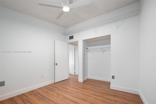 933 NE 199th St Unit 207, Miami, FL 33179 - unfurnished bedroom with wood finished floors, a closet, baseboards, and ceiling fan