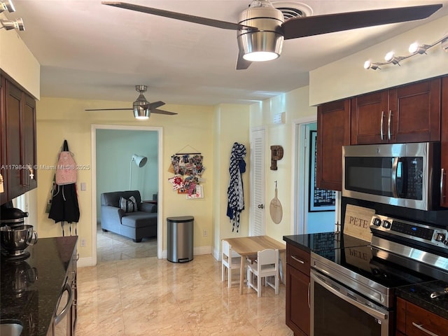 16195 SW 78th Ave, Palmetto Bay, FL 33157 - kitchen with appliances with stainless steel finishes, a ceiling fan, dark stone counters, and light marble finish floors