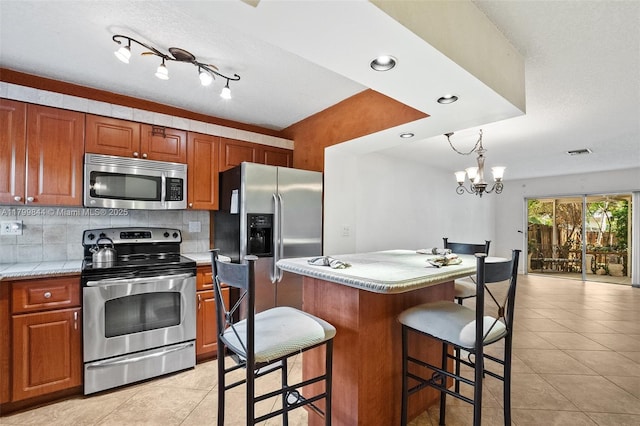 450 SE 7th St Unit 230, Dania Beach, FL 33004 - kitchen featuring appliances with stainless steel finishes, light tile patterned flooring, light countertops, backsplash, and recessed lighting