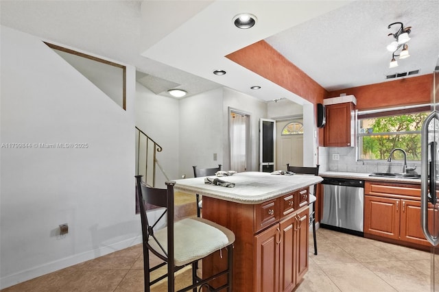 450 SE 7th St Unit 230, Dania Beach, FL 33004 - kitchen with dishwasher, a breakfast bar area, a sink, light tile patterned floors, and light countertops