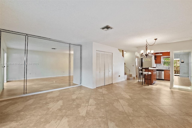 450 SE 7th St Unit 230, Dania Beach, FL 33004 - unfurnished living room featuring a chandelier, a textured ceiling, light tile patterned floors, stairs, and baseboards