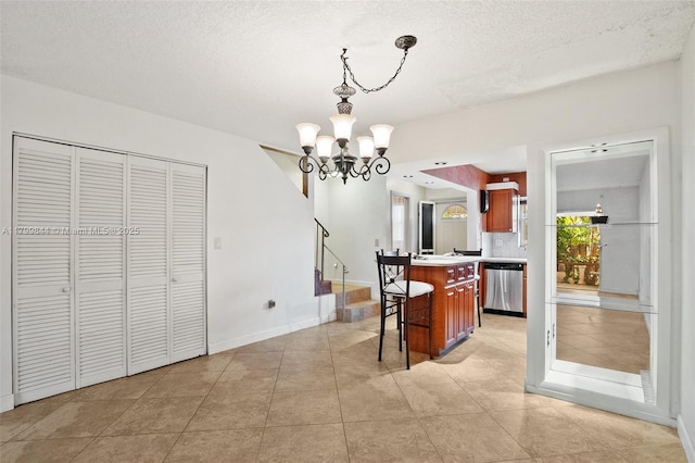 450 SE 7th St Unit 230, Dania Beach, FL 33004 - dining area featuring a chandelier, stairs, light tile patterned floors, baseboards, and a textured ceiling