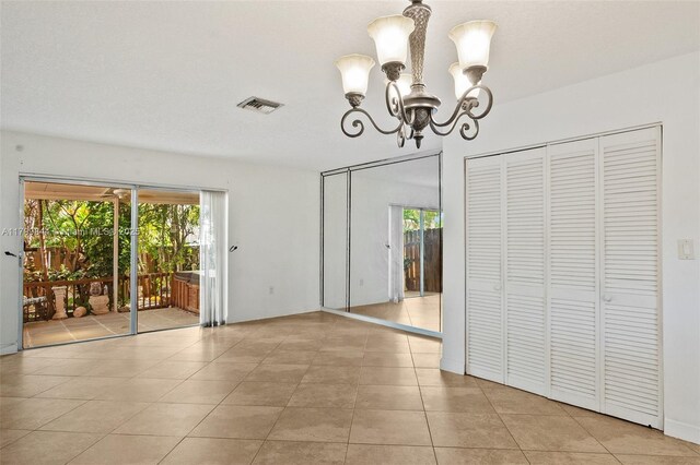 450 SE 7th St Unit 230, Dania Beach, FL 33004 - unfurnished dining area featuring a chandelier and light tile patterned floors