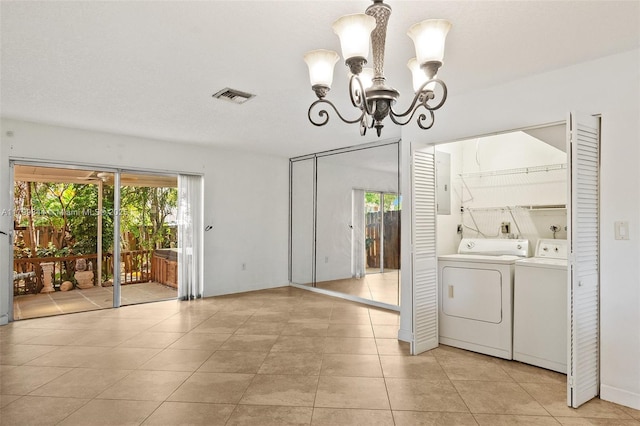 450 SE 7th St Unit 230, Dania Beach, FL 33004 - unfurnished dining area with separate washer and dryer, a chandelier, healthy amount of natural light, and light tile patterned floors