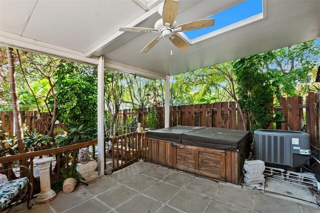 450 SE 7th St Unit 230, Dania Beach, FL 33004 - view of patio / terrace with a hot tub, central AC unit, a fenced backyard, and ceiling fan