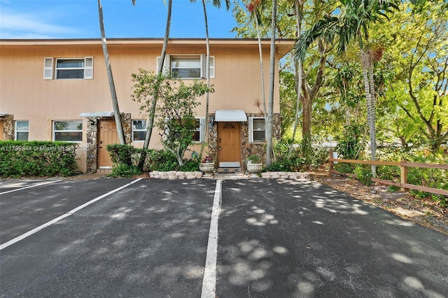 450 SE 7th St Unit 230, Dania Beach, FL 33004 - townhome / multi-family property featuring fence, uncovered parking, and stone siding