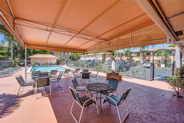 450 SE 7th St Unit 230, Dania Beach, FL 33004 - view of patio featuring fence and a community pool
