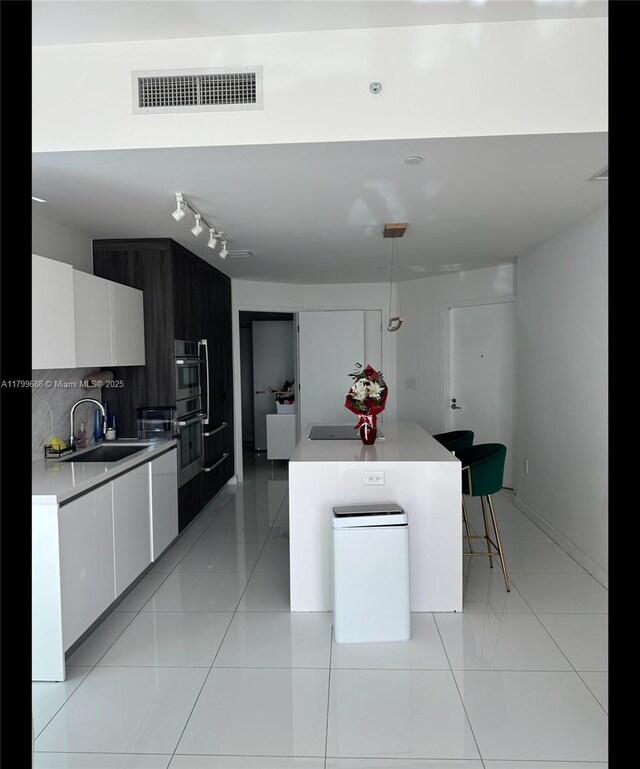 851 NE 1st Ave Unit 2208, Miami, FL 33132 - kitchen featuring a sink, modern cabinets, white cabinets, light countertops, and light tile patterned flooring