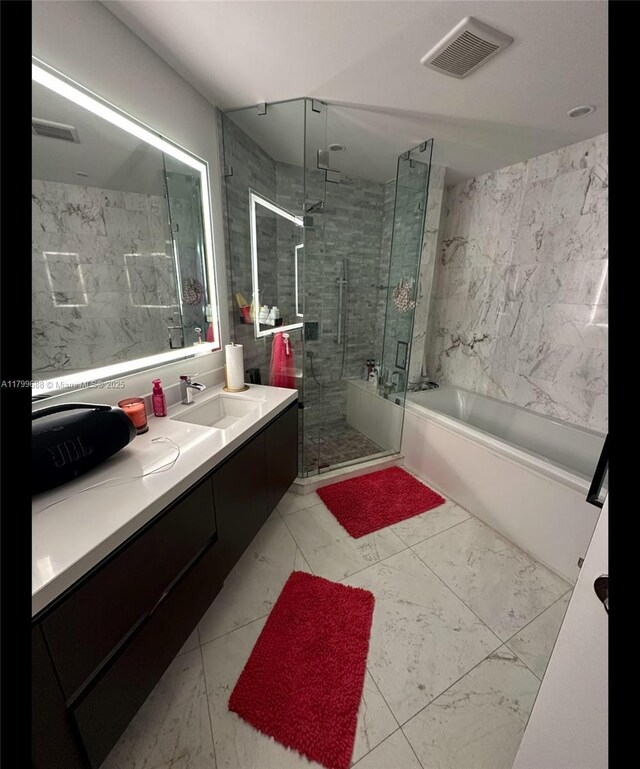 851 NE 1st Ave Unit 2208, Miami, FL 33132 - bathroom featuring a garden tub, vanity, a stall shower, and marble finish flooring
