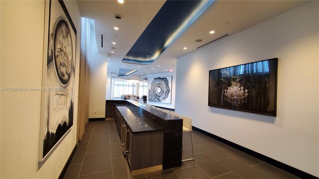 851 NE 1st Ave Unit 2208, Miami, FL 33132 - corridor with recessed lighting, baseboards, dark tile patterned floors, and a raised ceiling